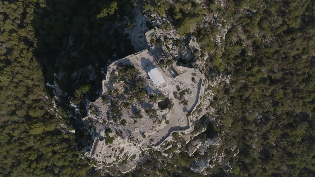 Screwdriver drone shot approaching the Castle of Monolithos, in sunny Rhodes