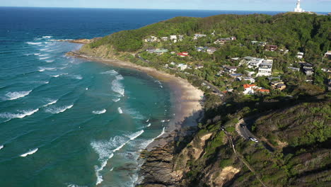 4k drone shot of the beautiful beach and surf town of byron bay, australia