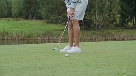 man putting on golf course