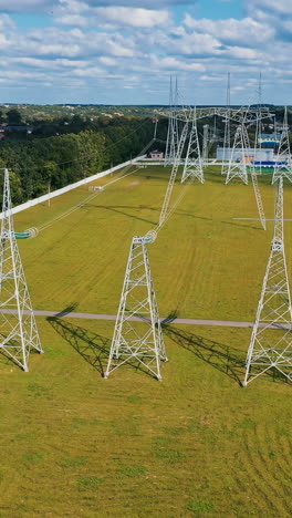 big electric distribution industry. high voltage construction lines aerial view. vertical video