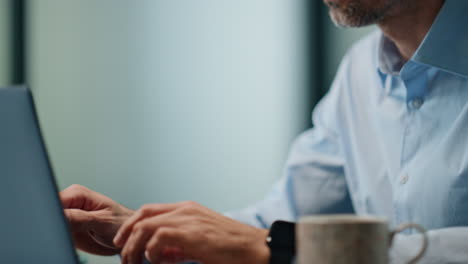 Thoughtful-man-working-computer-office-closeup.-Businessman-hands-typing-laptop