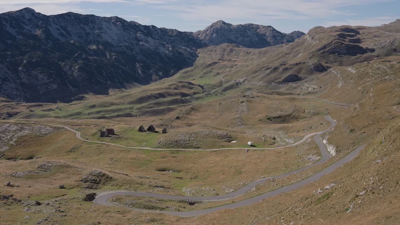 Road through rugged Durmitor mountains in Montenegro, wide static aerial