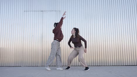 energetic female dancers performing choreography in urban setting