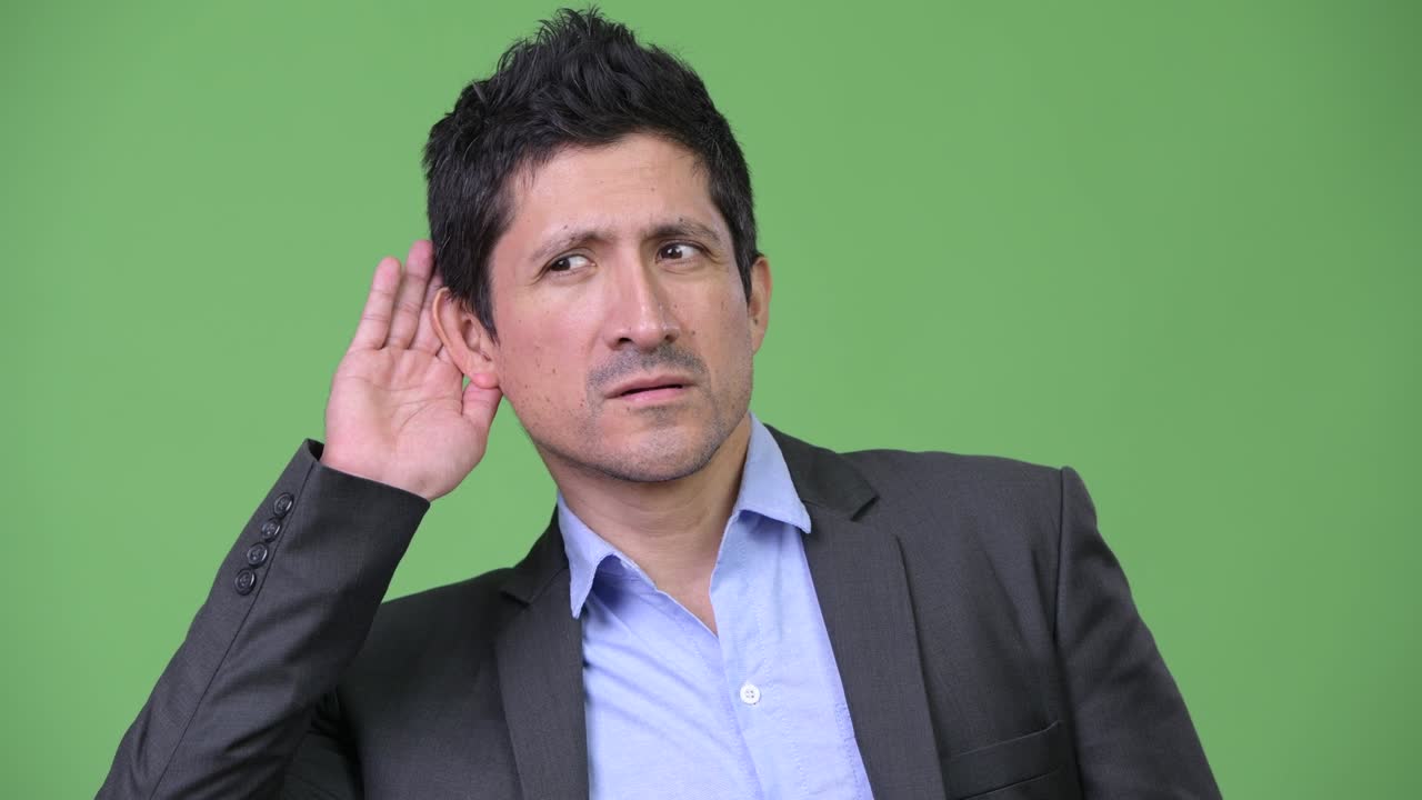 Hispanic businessman thinking while listening