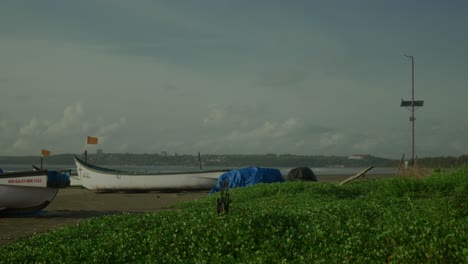 Los-Barcos-Descansan-Cerca-De-La-Playa-Alrededor-De-La-Hierba-Verde-En-Un-Día-Ventoso