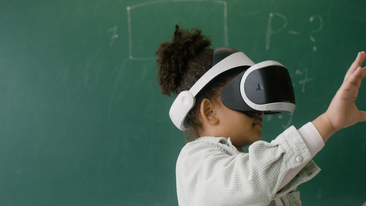 Little girl playing with VR glasses.