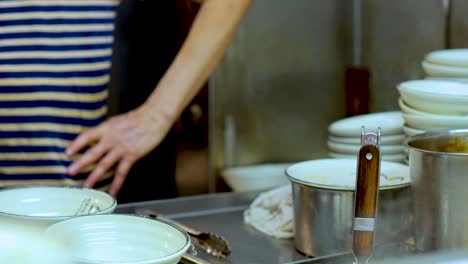 chef working with utensils and bowls in kitchen