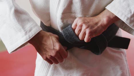 judoka tightening the black belt