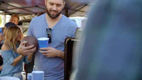 Slow-Motion-Shot-Of-Sports-Fans-Tailgating-In-Parking-Lot