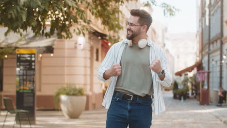 excited happy man shouting celebrating success winning goal achievement on urban city street