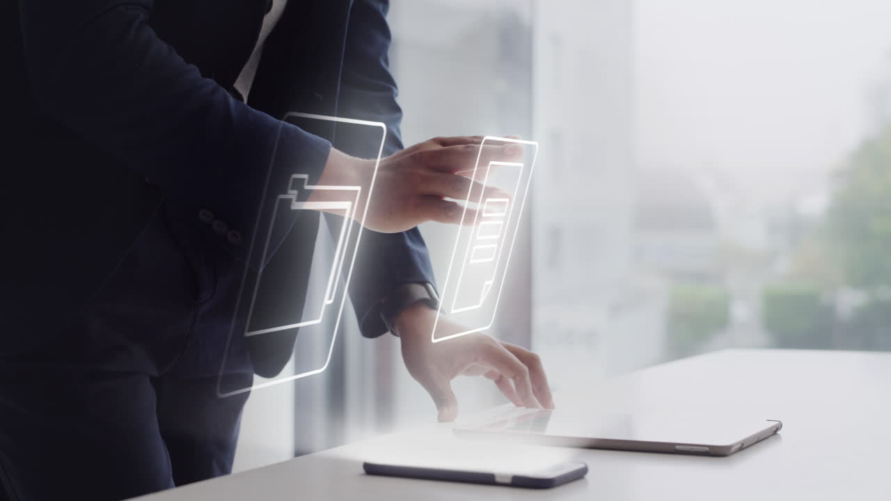 Businessperson Interacting with Digital Documents on Tablet and Laptop
