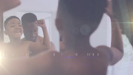 animación de luces sobre un feliz padre e hijo afroamericanos mirando al espejo y tomando una selfie