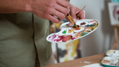 person mixing colors on the palette