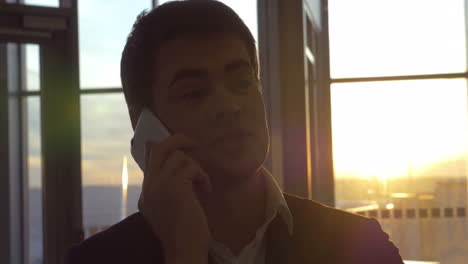 Young-man-chatting-on-the-phone-at-airport