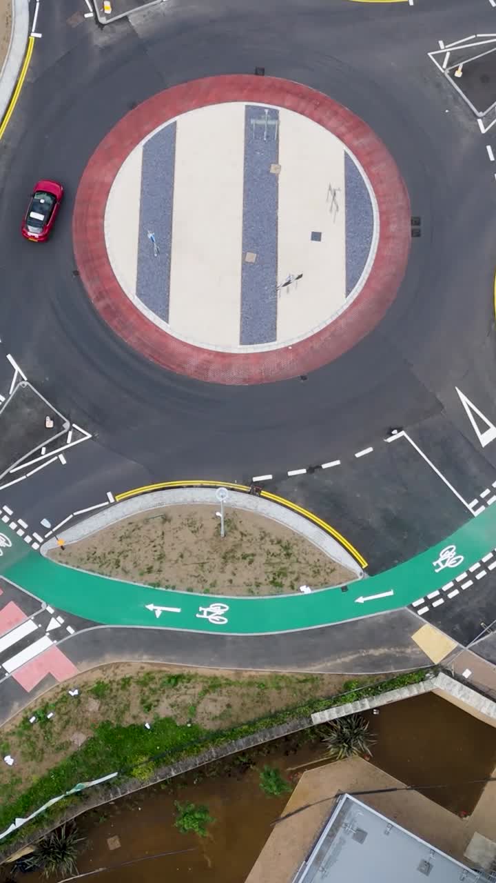 Vertical Elliptical drone orbit inward over Dutch roundabout in Hemel Hempstead, Herts