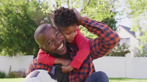 Porträt-Eines-Glücklichen-Afroamerikanischen-Vaters-Mit-Seinem-Sohn,-Der-Fußball-Hält