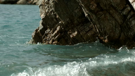 waves crashing against rocks on a coastal shore