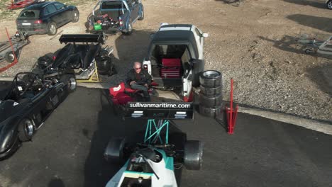 customized race cars parked on the road side at the hill in imtahleb malta on a sunny day - aerial shot