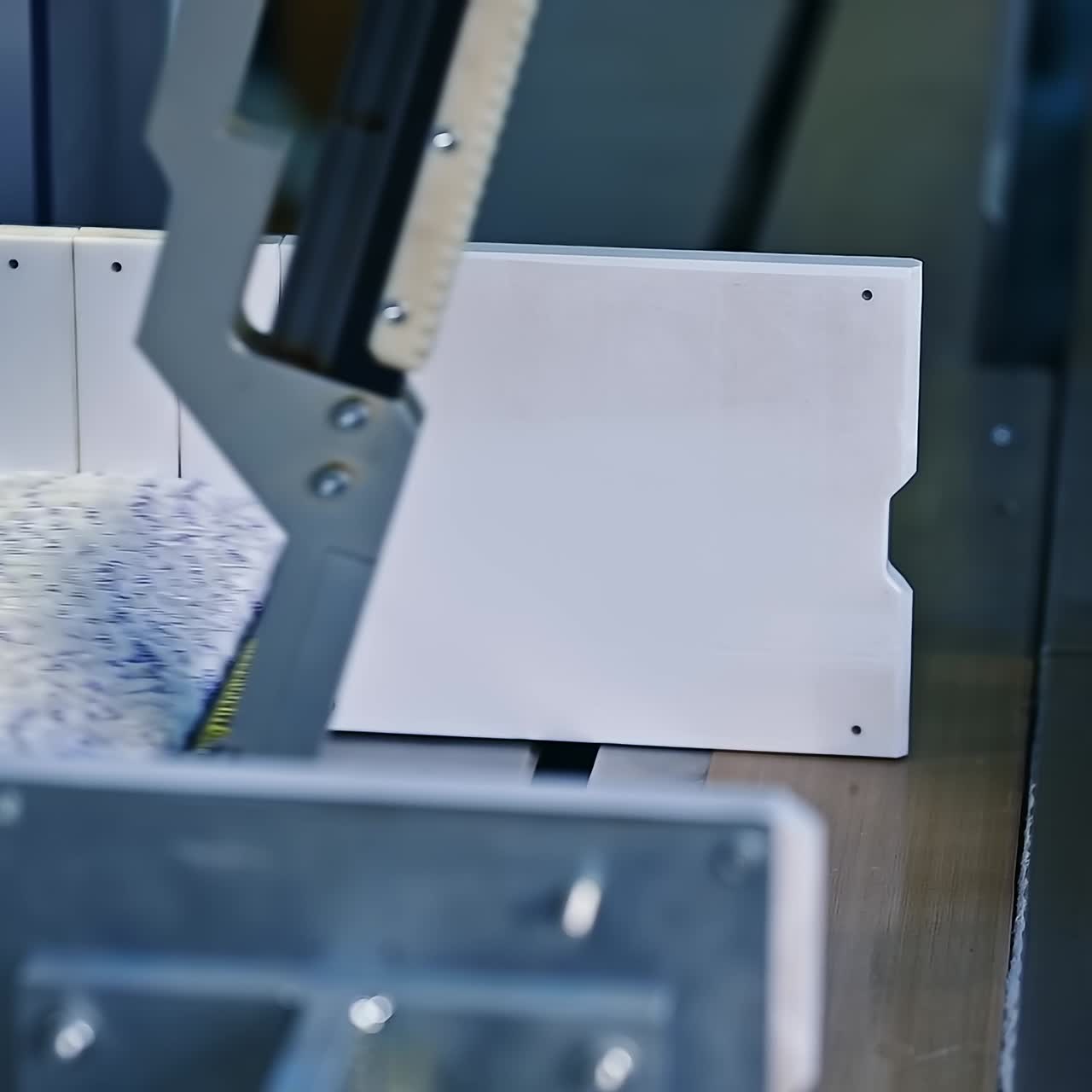 Mechanical packaging of diapers. A batch of diapers is packed on a special machine