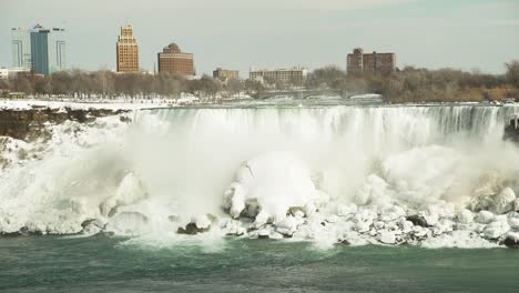 static view of niagara falls and building skyline in wintertime canada