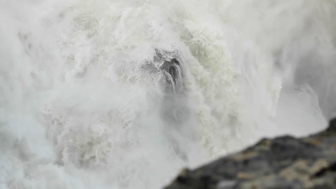 Water flowing over rock in waterfall