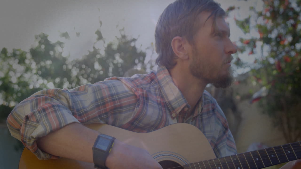 Mid adult guitarist sitting backyard showing floating notes and smartwatch data for music education