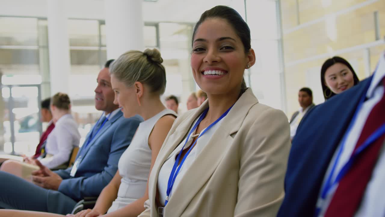 Businesswoman looking at camera during seminar 4k