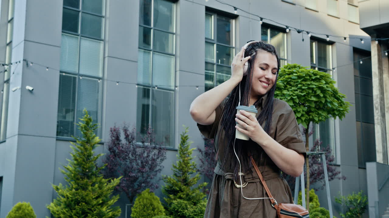 Woman enjoying music and coffee outdoors