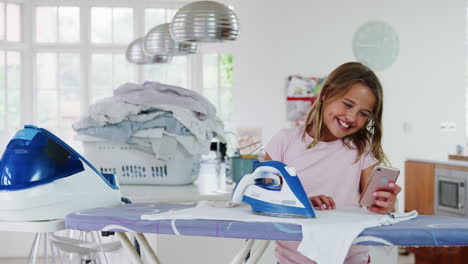 Girl-Using-Mobile-Phone-Burns-Clothes-Whilst-Ironing