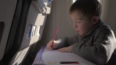 child drawing during the flight