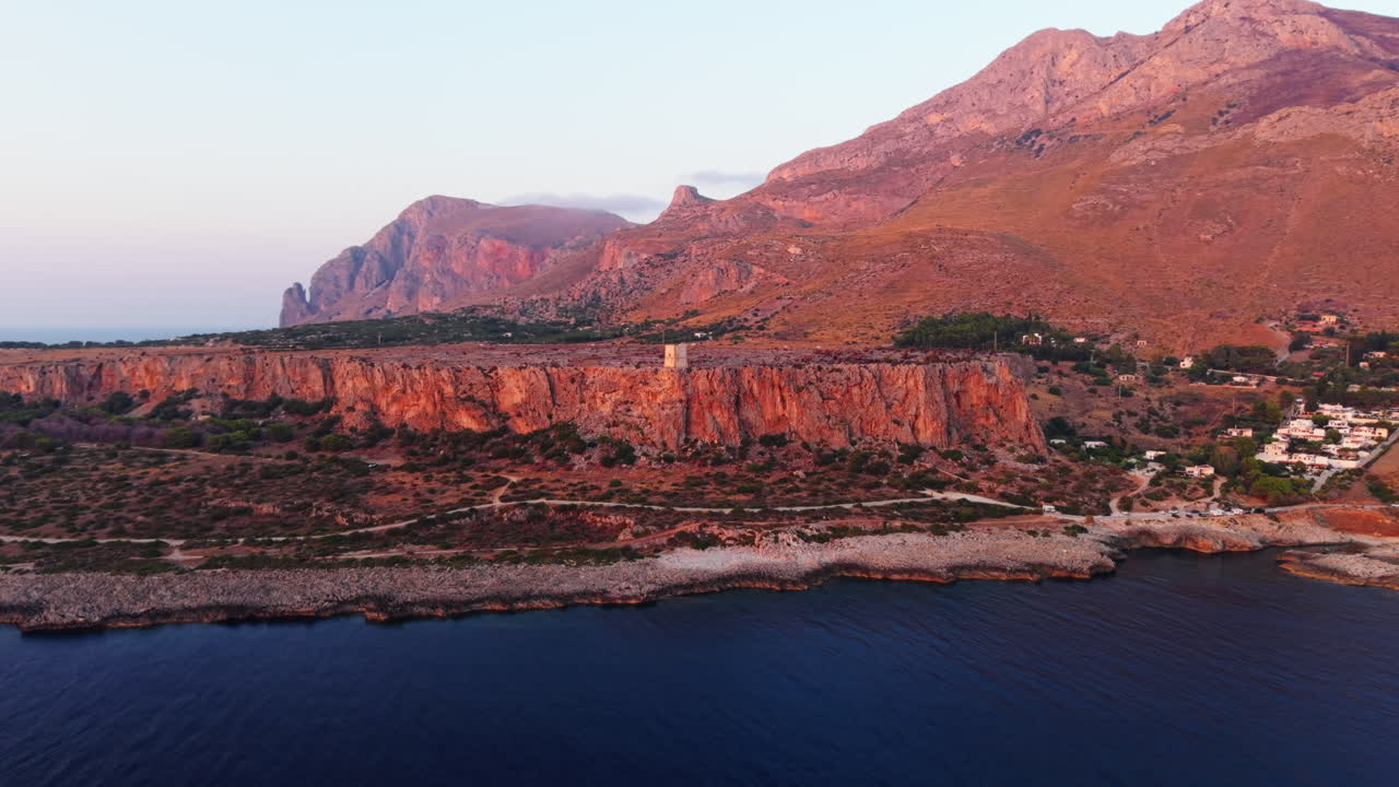 Coastal cliffs of Sicily at sunset, serene and picturesque landscape