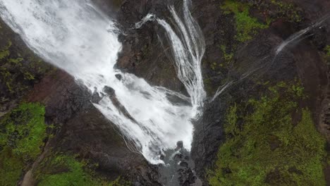 Aerial-overhead-shot-of-crashing-Glymur-Waterfall-in-Iceland-during-cloudy-day