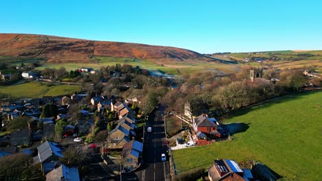 aerial drone video footage of the small rural village of denshaw, a typical rural village in the heart of the pennine hills