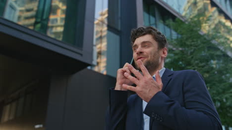 happy man calling street modern residential area close up. businessman talking