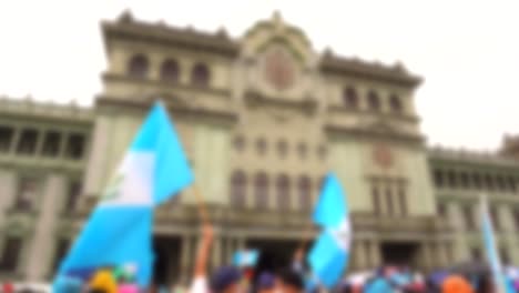 blurred flags in front of guatemalan government