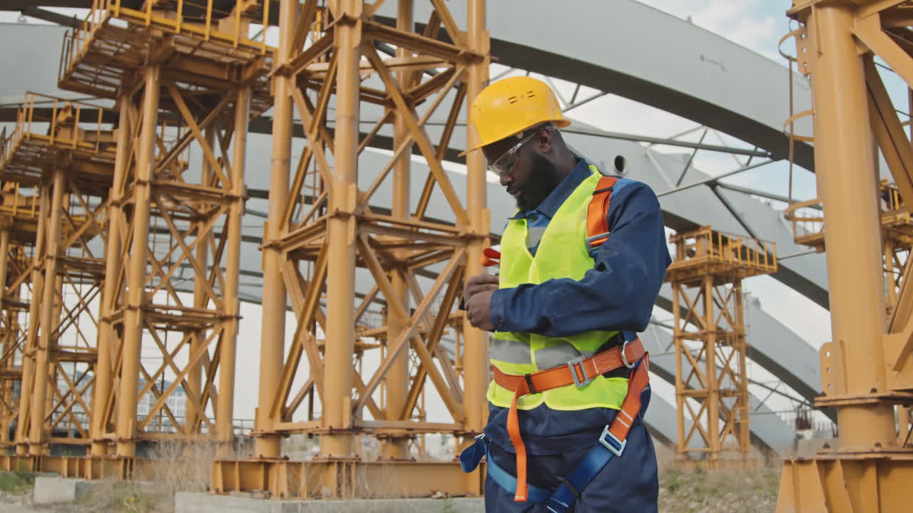 Male Construction Worker Putting On Safety Belt