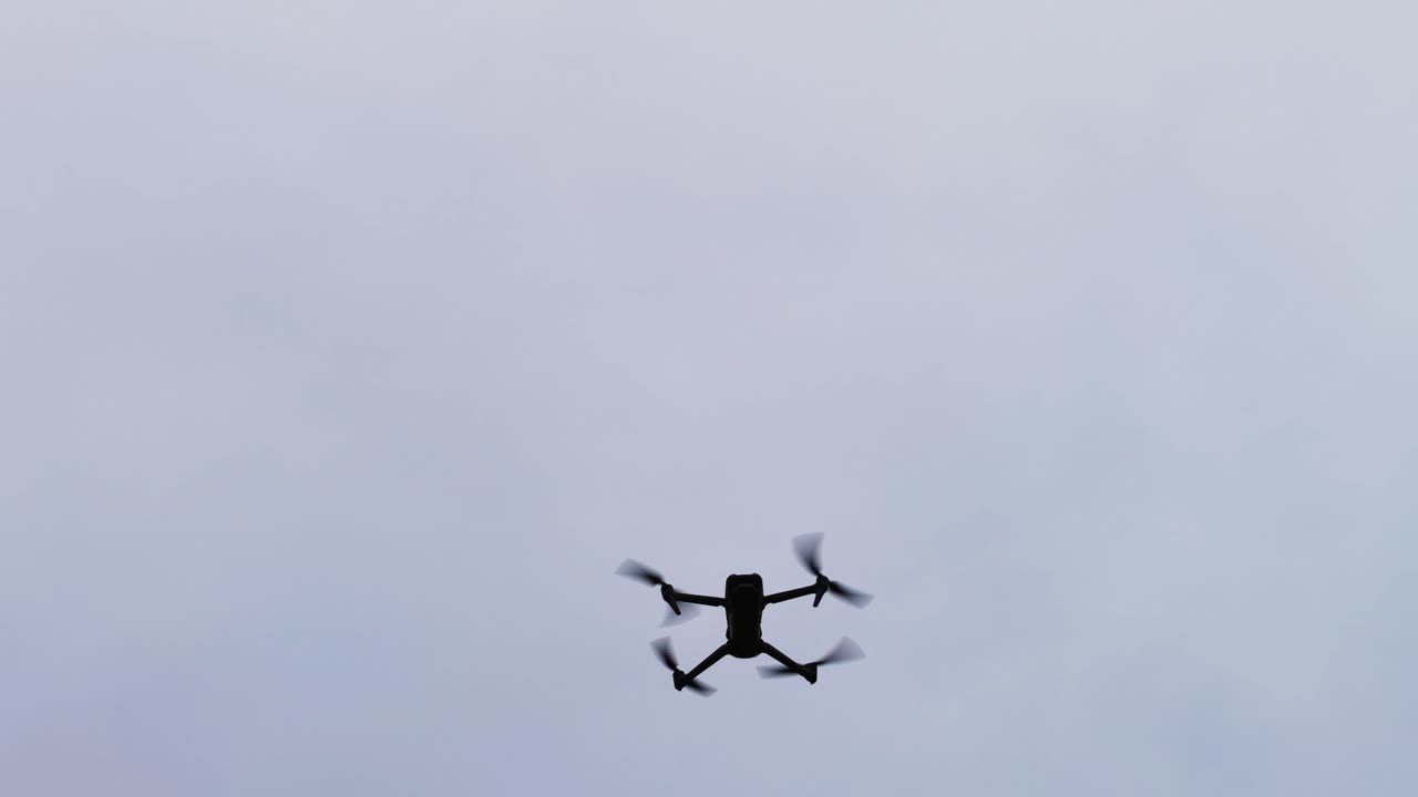 Unmanned aircraft descend during flight on cloudy sky background, Czechia