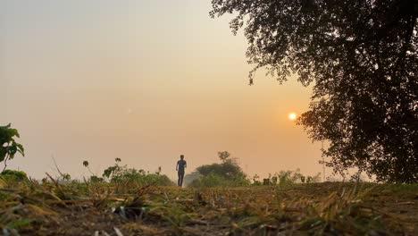 Majestic-low-angle-shot-of-jogger-running-towards-camera-at-sunset,-morning-run