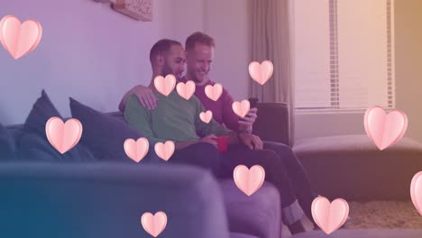 animation of heart icons over happy diverse gay couple embracing