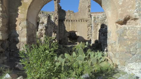 Drone-Dolly-in-of-a-ruin-with-cactus-in-the-Pueblo-Fantasma-in-Real-de-Catorce,-San-Luis-Potosi,-Mexico