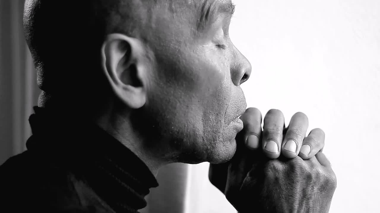 orando a dios con las manos juntas sobre fondo blanco con gente almacen de metraje de video