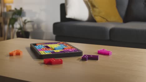 coloured interlocking shape puzzle on table at home for child diagnosed with asd 2