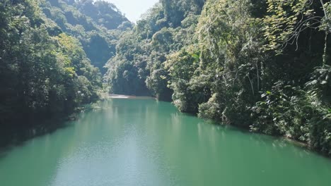 Scenic-aerial-in-dense-green-forest-with-green-lake-in-the-Dominican-Republic