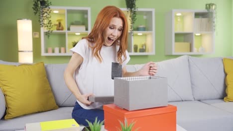 smiling cheerful young woman opening gift boxes.