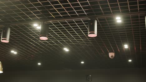 modern ceiling featuring grid patterns, recessed lighting, pendant lamps, and a ventilation system. sleek, contemporary design in a retail or commercial space