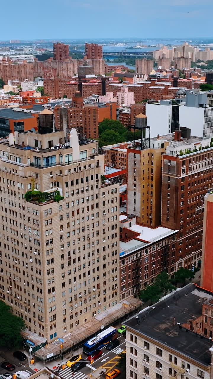Varied multistoried buildings of New York. Approaching large white house with garden on top. Aerial view. Vertical video