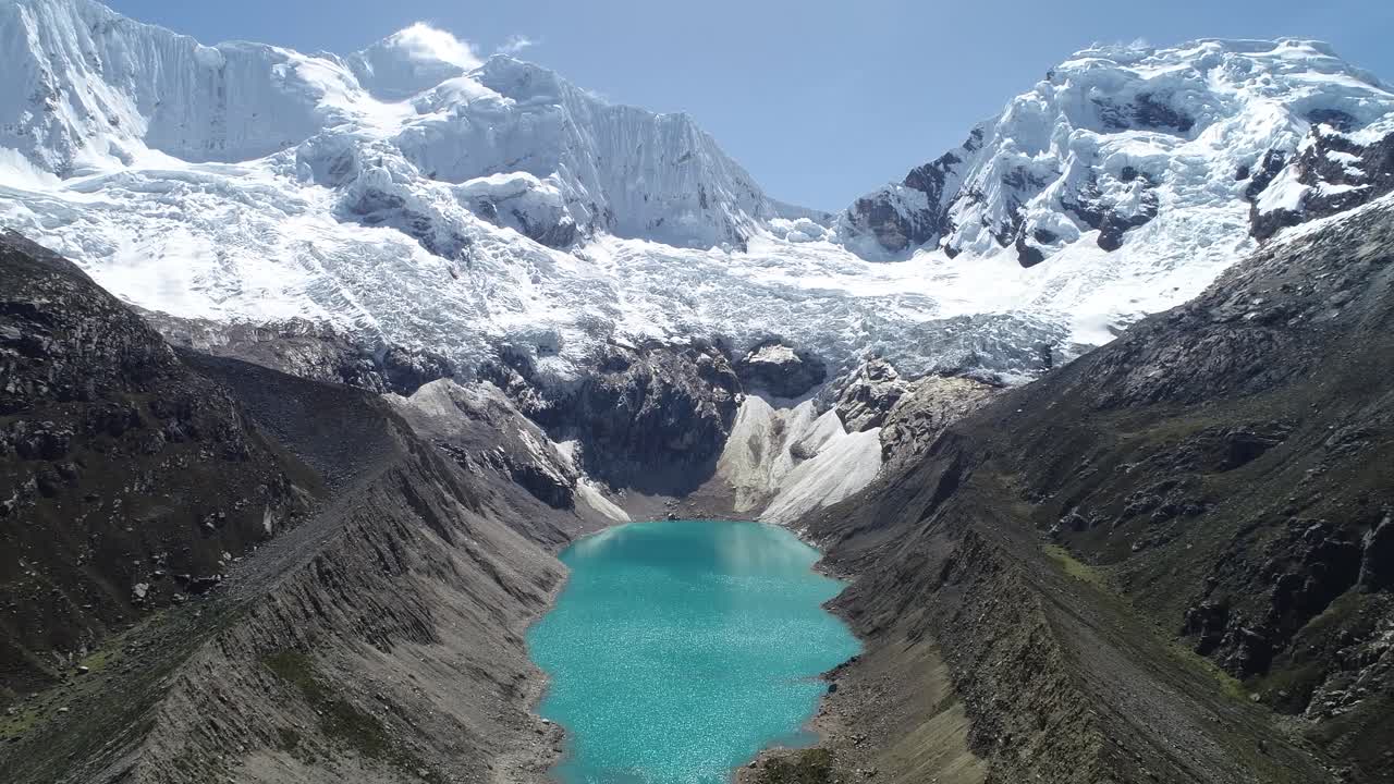 A breathtaking glacial lagoon with turquoise waters, surrounded by towering snow-capped peaks. Ideal for travel blogs, adventure videography, and high-quality video.