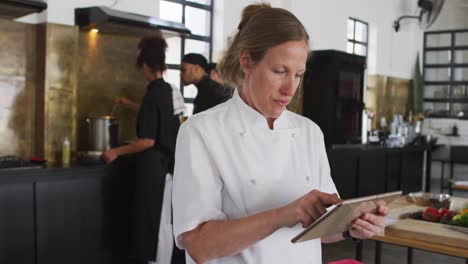 cocinera caucásica que enseña a un grupo diverso