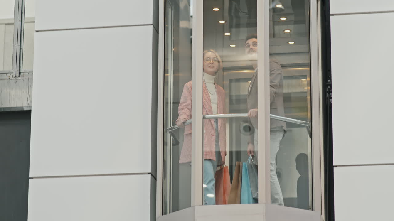 Stylish Couple In Elevator At Shopping Centre