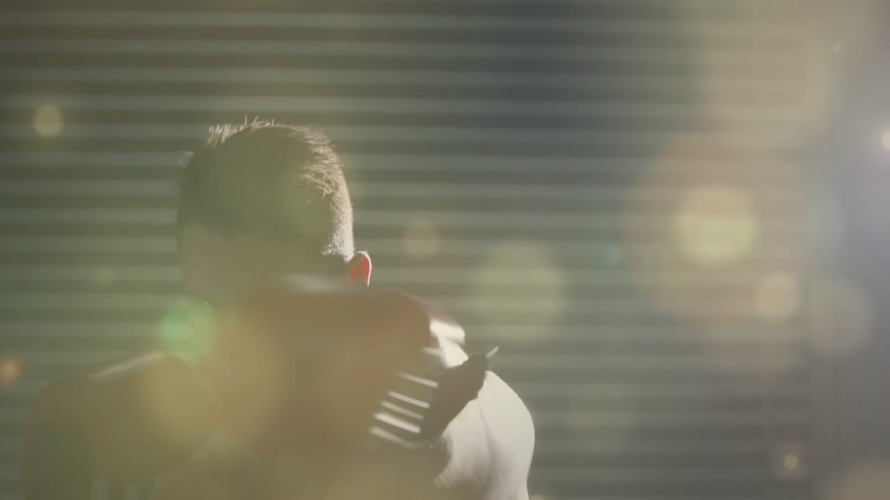 Boxer starting in guard throwing jabs and hooks for fitness drills shedding top red gloves flashing